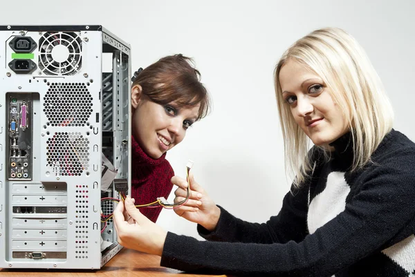 Две девочки, ремонт компьютера — стоковое фото